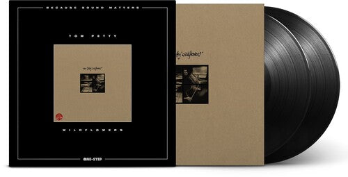 Vinyl record with a black cover featuring text and images, on a white background.